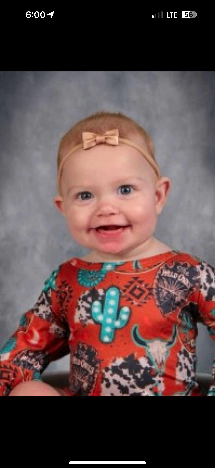 Kinsley is registered to the contest to win money with this photo: baby, child, portrait, smiling, headband, bow, face, blue_eyes, colorful_clothing, patterned_outfit, southwestern_style, indoor, studio, happy, cute, infant, person, photography, background, sitting