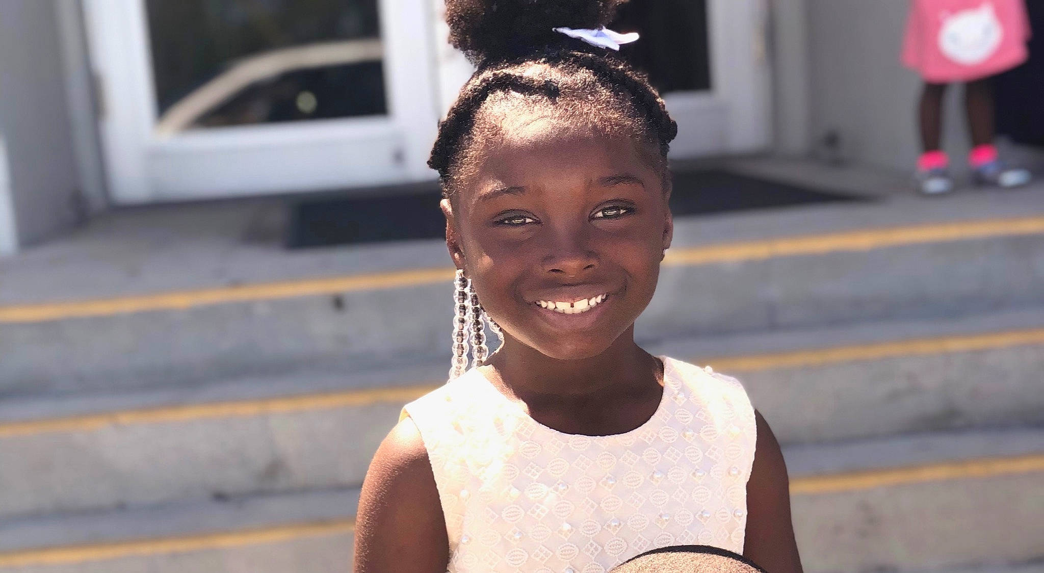 Wilniyah is registered to the contest to win money with this photo: adaptation, black_hair, child, cornrows, ear, face, facial_expression, forehead, fun, hair, hair_accessory, hairstyle, happy, head, human, joy, neck, people, person, smile