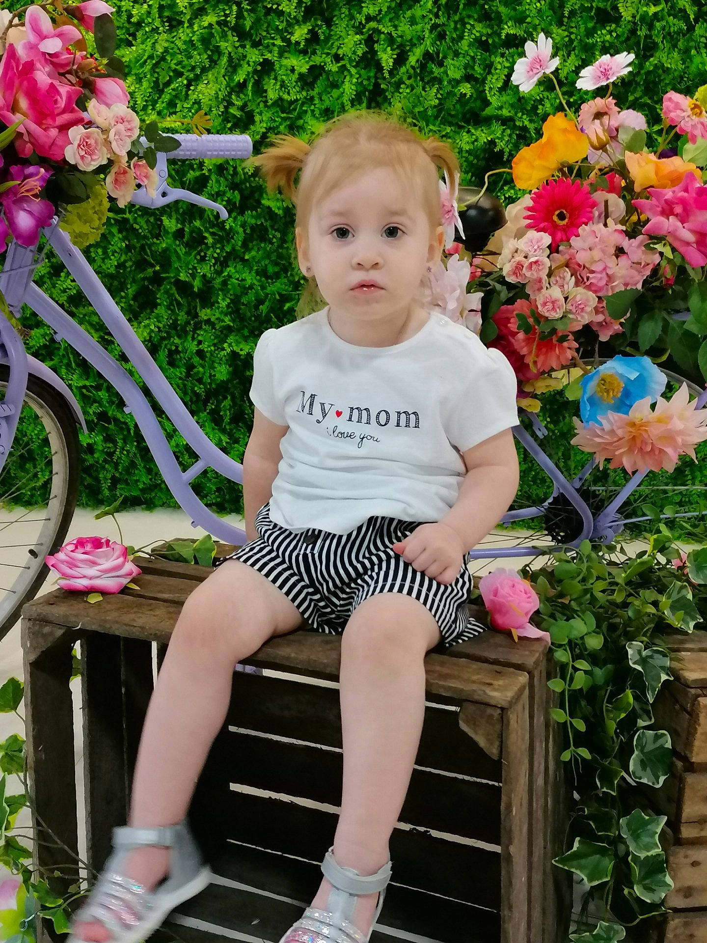 Lyloo participe au concours pour gagner de l'argent avec cette photo : baby_toddler_clothing, bicycle, bicycle_wheel, dress, face, facial_expression, flower, grass, green, hairstyle, happy, leg, leisure, people_in_nature, person, pink, plant, product, shoe, tire