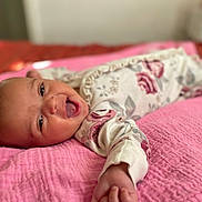 Daviana joined the competition — help win amazing prizes! baby, infant, smiling, happy, lying_down, blanket, pink, floral_clothing, cute, portrait, indoors, soft_focus, child, skin, hand, face, expression, newborn, cozy, comfort
