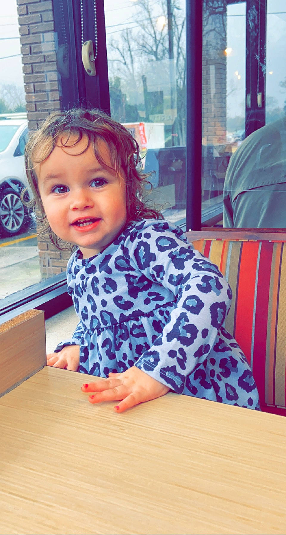 Tinsley is registered to the contest to win money with this photo: baby_toddler_clothing, car, chair, child, desk, facial_expression, flooring, fun, happy, headwear, leisure, person, sleeve, smile, t_shirt, table, tire, toddler, varnish, wheel