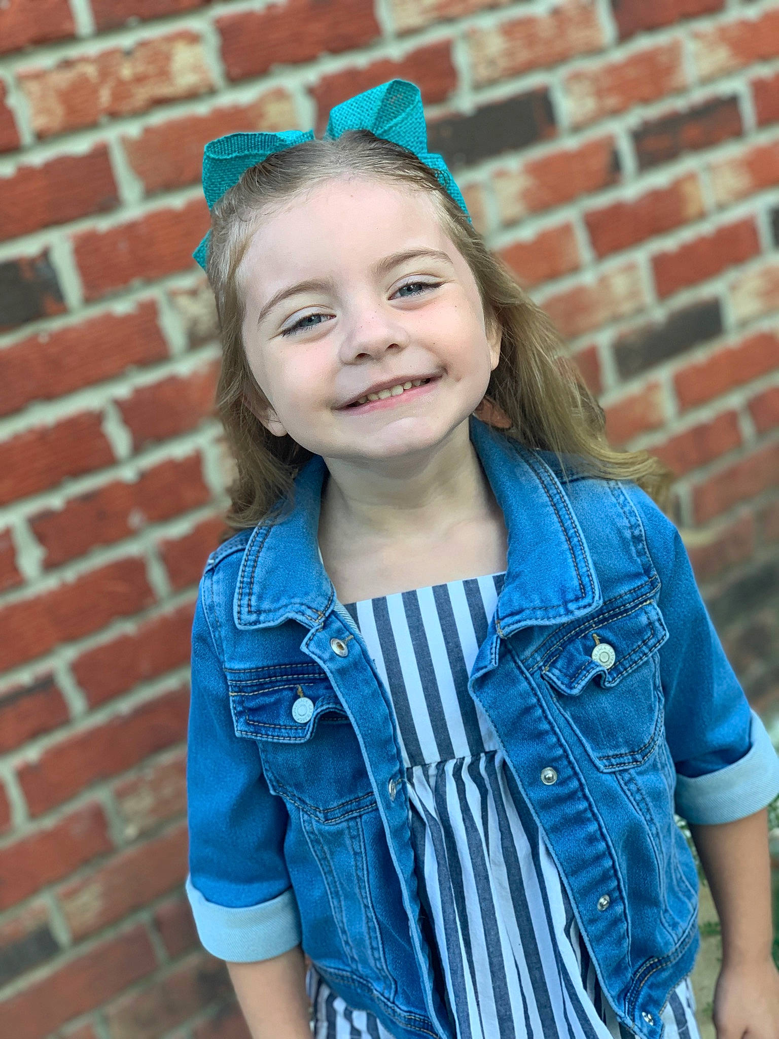 Emmalyn is registered to the contest to win money with this photo: azure, blue, brick, cool, denim, eye, flash_photography, hair, happy, head, iris, joy, lip, neck, organ, person, pink, skin, sleeve, smile