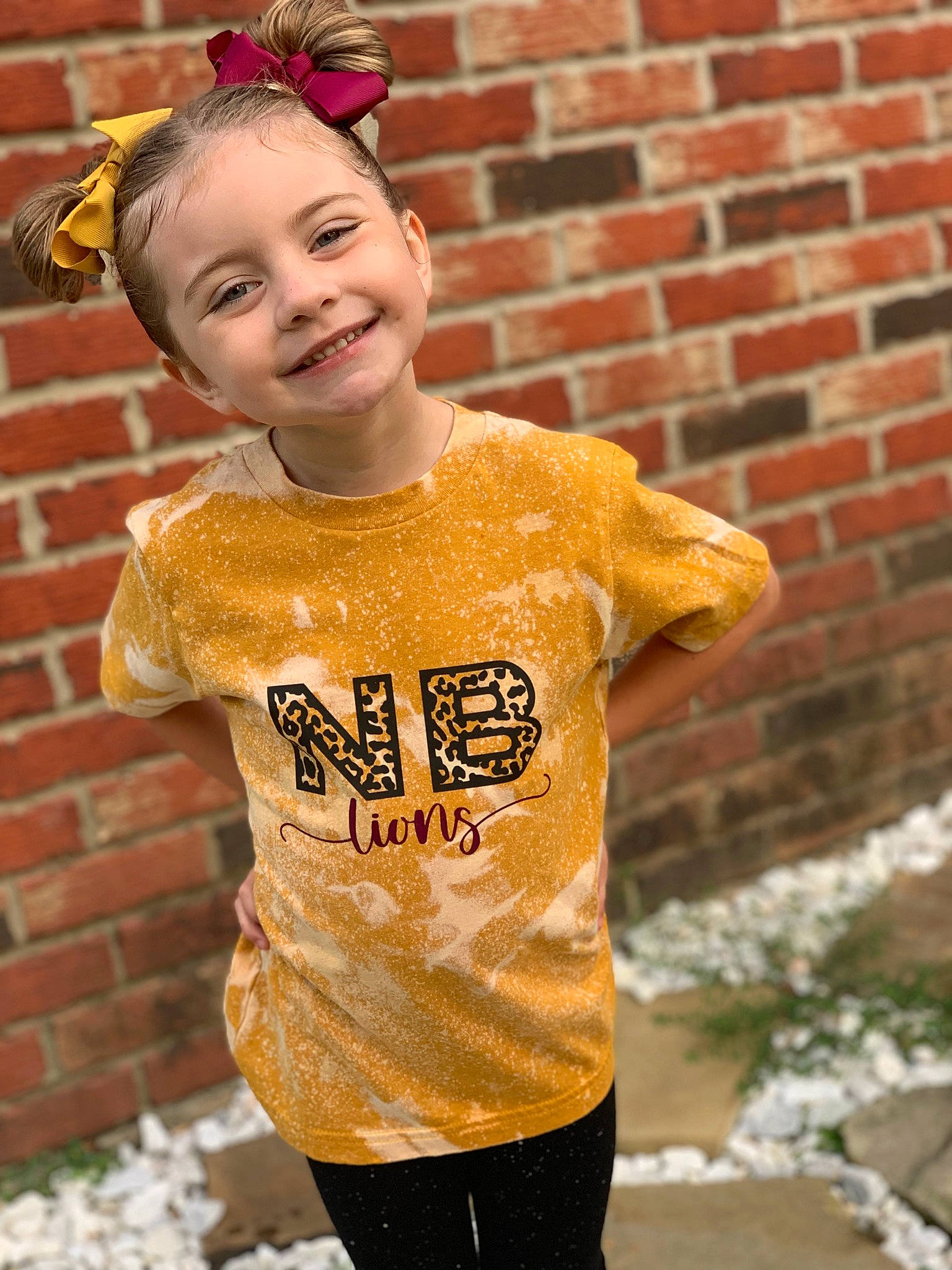 Emmalyn is registered to the contest to win money with this photo: brick, brickwork, clothing, cool, face, facial_expression, hairstyle, happy, head, headgear, human_body, joy, neck, orange, person, pink, shoulder, sleeve, smile, street_fashion