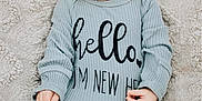 Cole joined the competition — help win amazing prizes! baby, infant, red_hair, onesie, text_on_clothing, blanket, lying_down, cute, newborn, person, skin, feet, hands, portrait, child, soft_texture, cozy, expression, casual_clothing, indoor