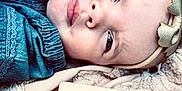 Emberlyn joined the competition — help win amazing prizes! baby, infant, face, headband, denim, clothing, blanket, milestone_card, portrait, lying_down, close_up, child, cute, skin, expression, head, soft_texture, indoor, young, person