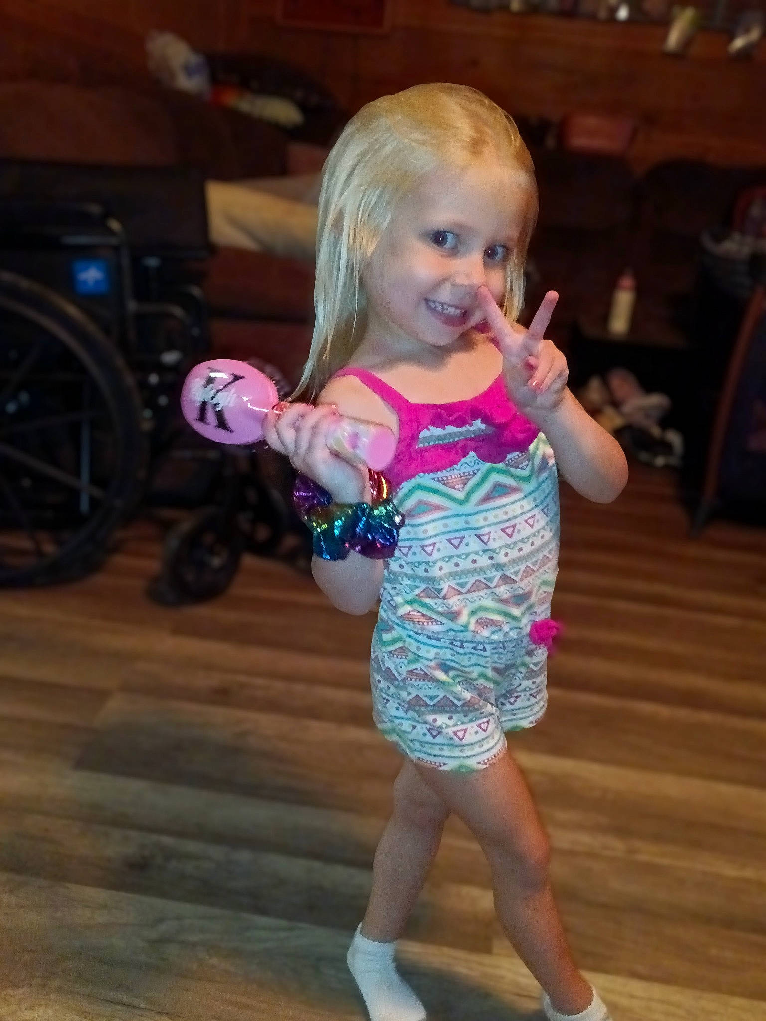 Kyliegh is registered to the contest to win money with this photo: baby_toddler_clothing, child, electric_blue, event, floor, flooring, fun, happy, hardwood, head, human_leg, joy, person, purple, skin, smile, standing, thumb, tire, toddler