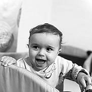 Nikolas joined the competition — help win amazing prizes! baby, toddler, child, smiling, happy, face, expression, hand, clothing, indoor, black_and_white, portrait, cute, young, person, furniture, playpen, background, decor, wall