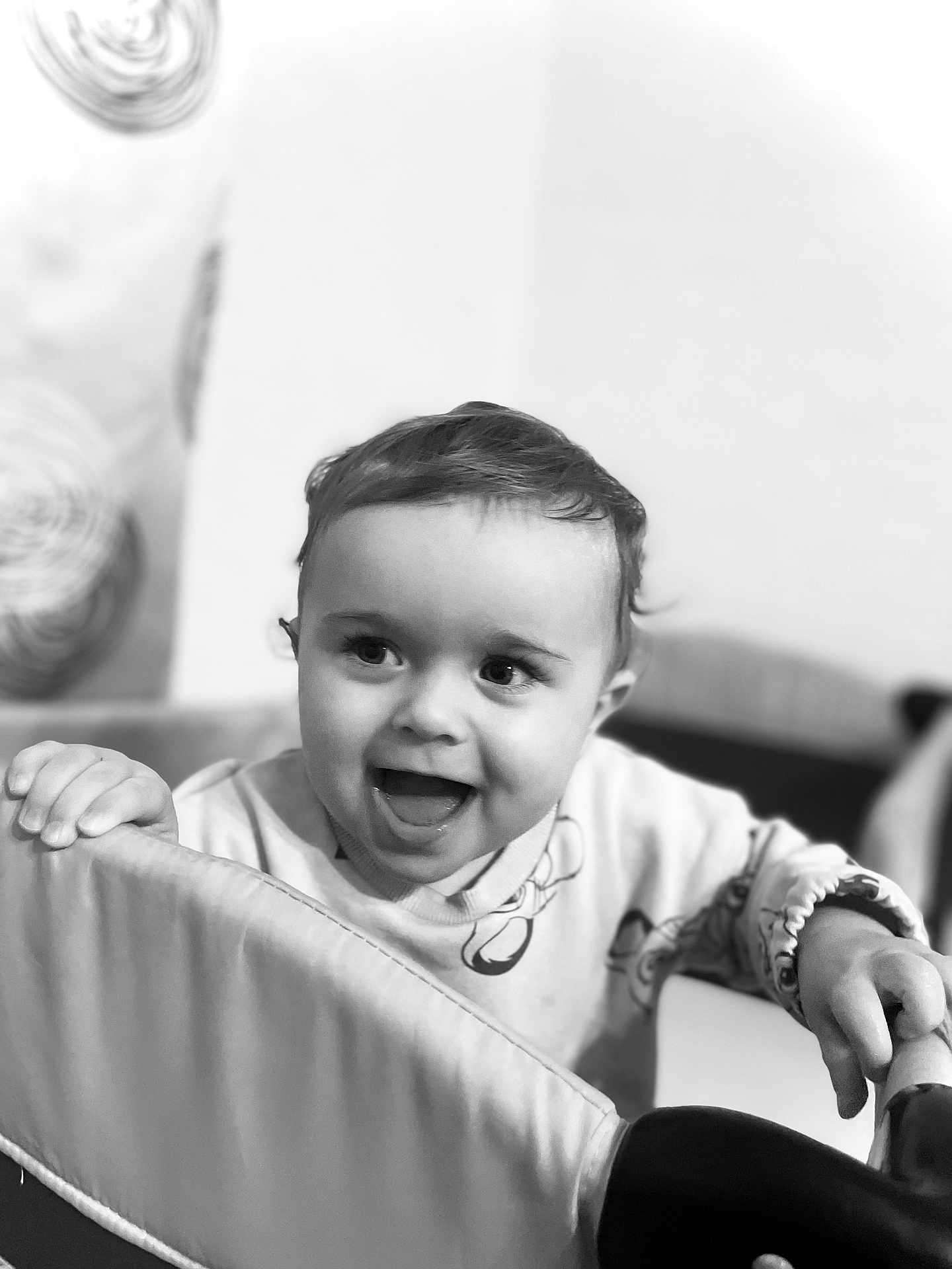 Nikolas joined the competition — help win amazing prizes! baby, toddler, child, smiling, happy, face, expression, hand, clothing, indoor, black_and_white, portrait, cute, young, person, furniture, playpen, background, decor, wall