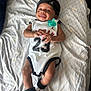 Ahmir Lamelo joined the competition — help win amazing prizes! baby, infant, smile, lying_down, pacifier, headband, jordan, sportswear, socks, bed, blanket, pattern, cute, happy, child, person, indoors, clothing, footwear, portrait