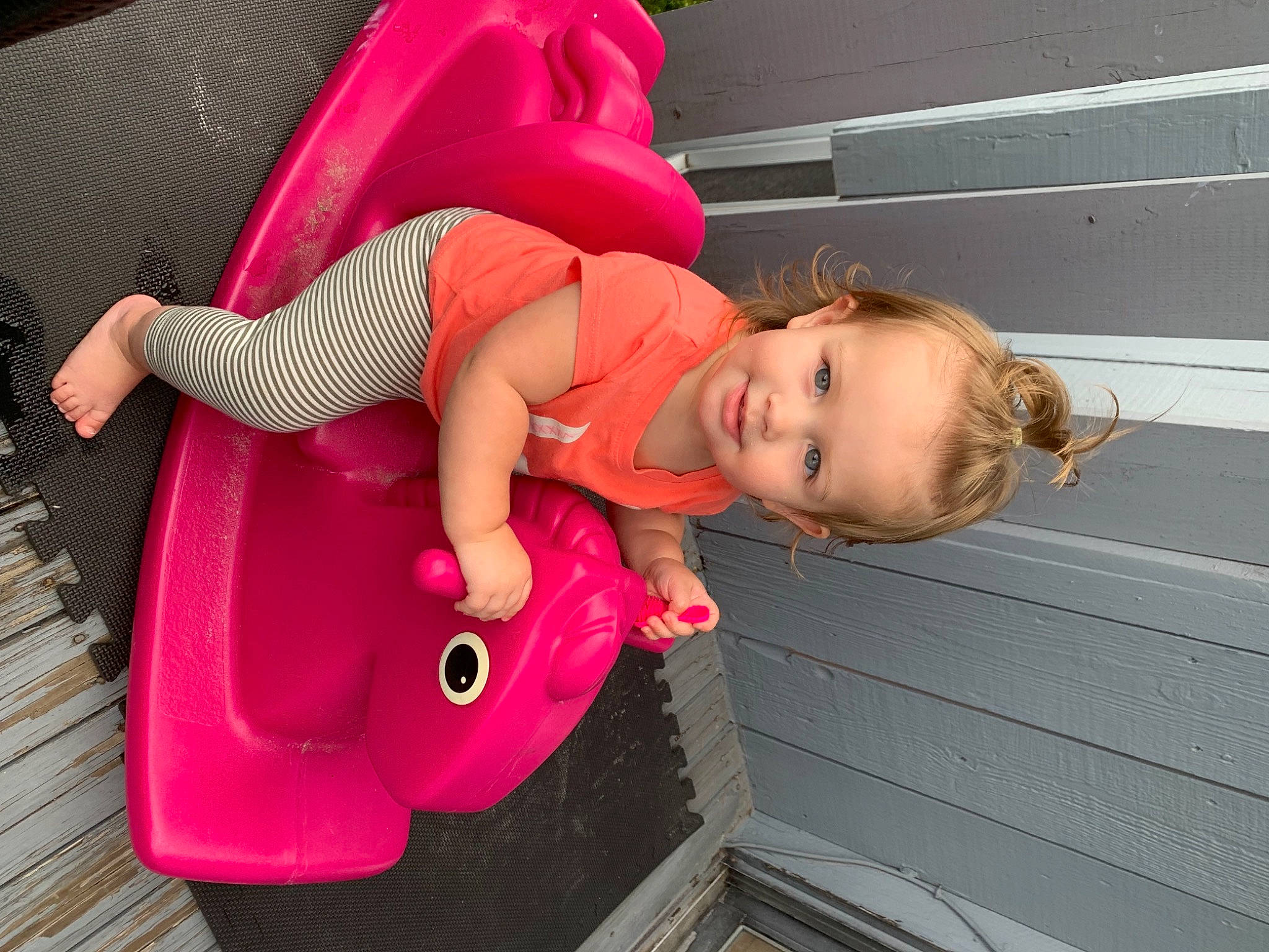 Gianna is registered to the contest to win money with this photo: baby, baby_products, baby_toddler_clothing, cheek, child, flooring, fun, happy, human_body, joy, leg, leisure, magenta, mouth, people, person, pink, sandal, skin, smile