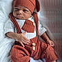 Marcus Mitchell joined the competition — help win amazing prizes! baby, infant, hat, knitwear, overalls, white_socks, blanket, cute, portrait, child, fashion, warm_clothing, cozy, expression, face, hands, indoor, soft_texture, button, sitting