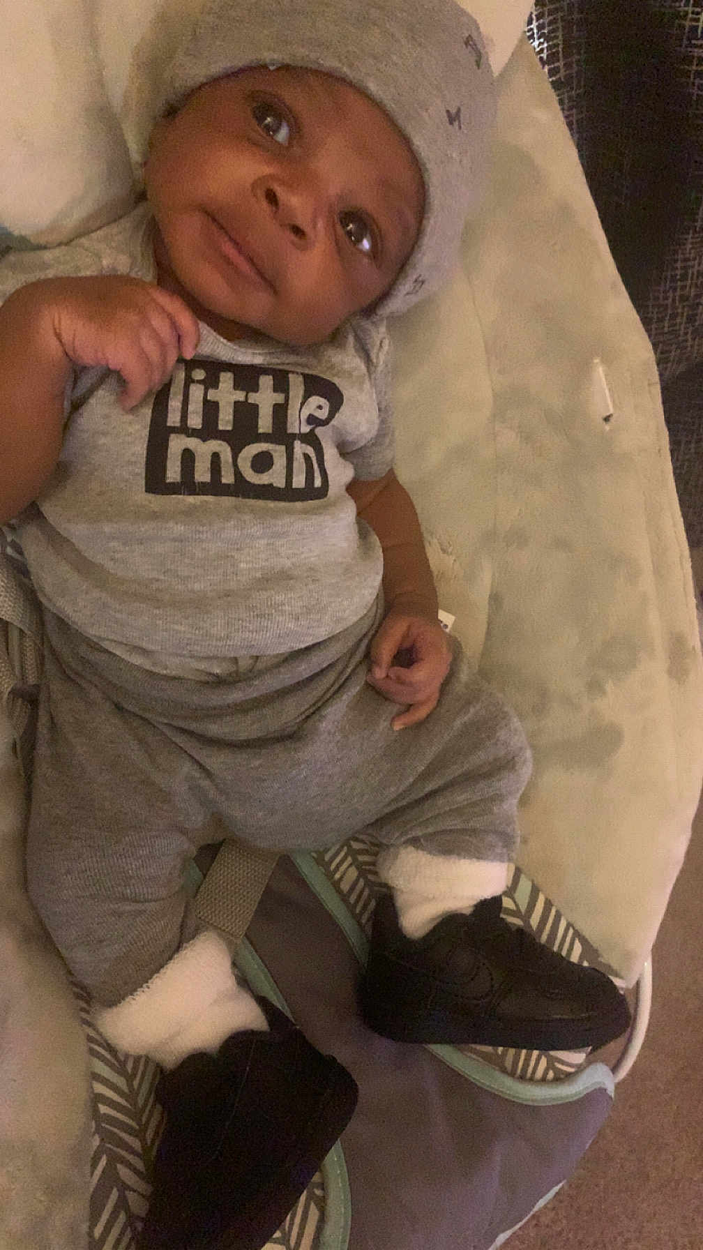 Marcus Mitchell joined the competition — help win amazing prizes! baby, infant, clothing, hat, sneakers, gray, cute, child, lying_down, soft_surface, portrait, small_shoes, toddler, cozy, indoors, curious, face, hands, apparel, footwear
