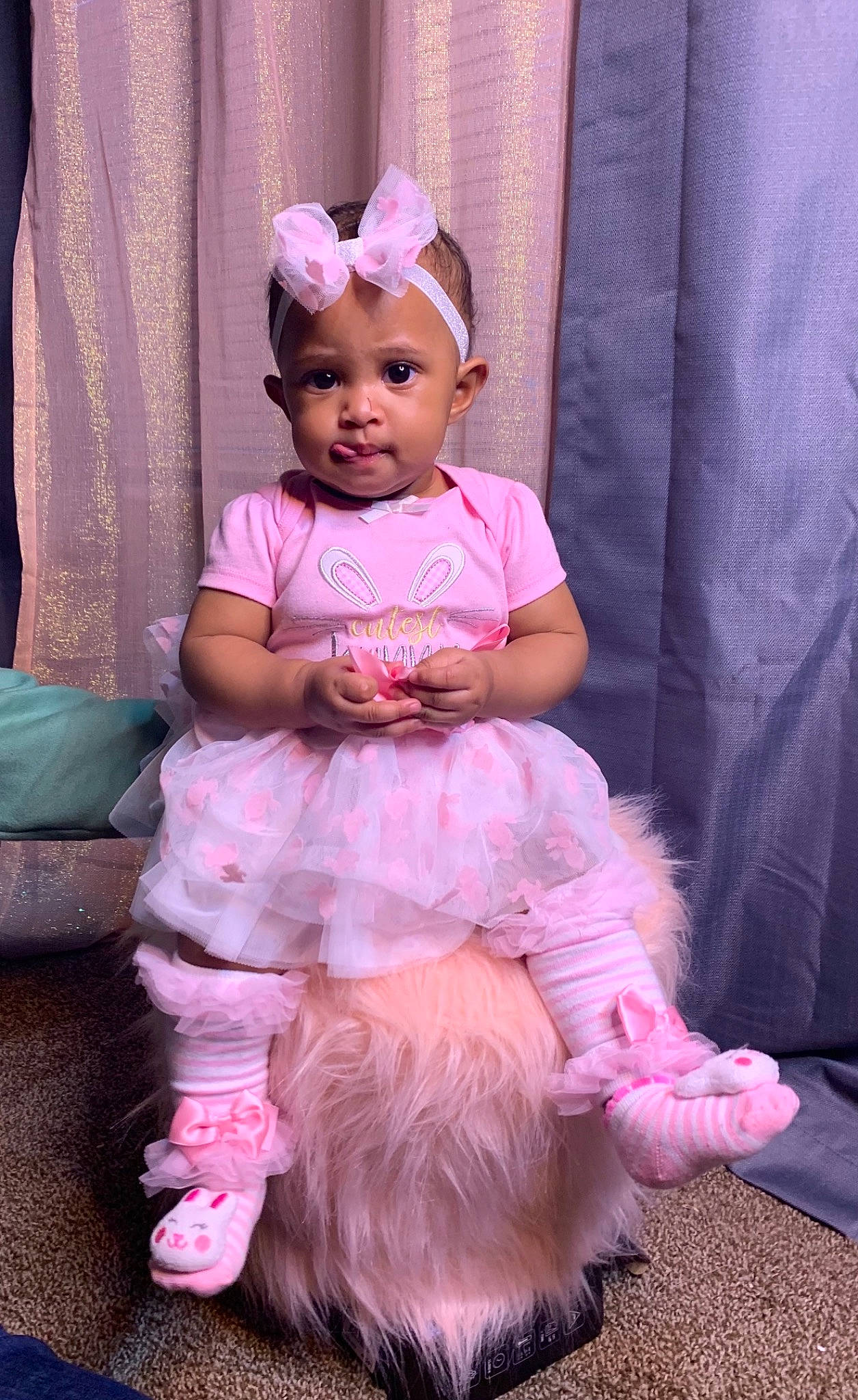 Kendall is registered to the contest to win money with this photo: baby, baby_toddler_clothing, child, curtain, event, fashion_accessory, fun, hairstyle, happy, headpiece, headwear, jewellery, magenta, person, pink, purple, sitting, skin, sleeve, smile
