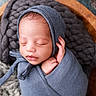 Caiden is registered to the contest to win money with this photo: newborn, baby, sleeping, swaddle, blue_bonnet, wooden_bowl, knitted_blanket, cozy, peaceful, infant, portrait, closeup, cute, child, headwear, soft_texture, resting, indoors, wrapped, tiny_hand