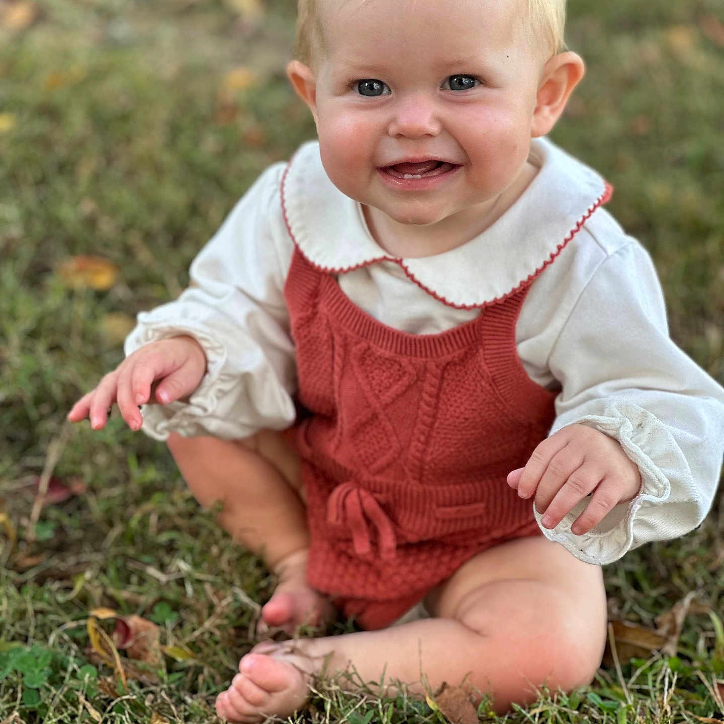 Lynlee joined the competition — help win amazing prizes! baby, barefoot, blonde_hair, blue_eyes, child, collar, cute, face, fall_leaves, grass, happy, knitwear, nature, outdoor, portrait, romper, sitting, smiling, white_blouse, young_child
