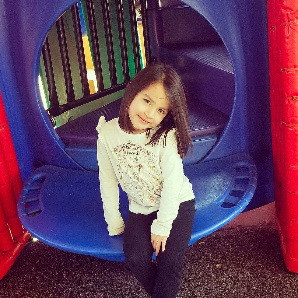 Cassi Joe is registered to the contest to win money with this photo: beauty, blue, child, eye, fun, jeans, joy, leg, outdoor_play_equipment, person, pink, play, playground, playground_slide, public_space, recreation, red, sitting, smile, snapshot