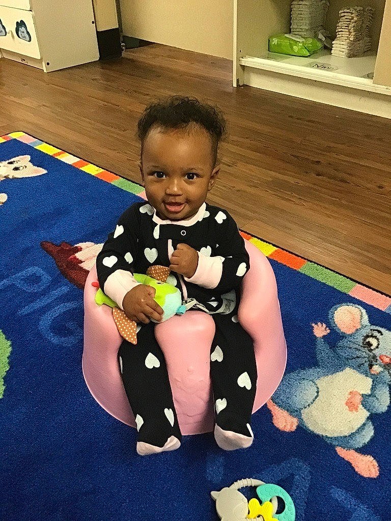 Irie is registered to the contest to win money with this photo: baby, baby_playing_with_toys, baby_products, baby_toddler_clothing, baby_toys, child, floor, flooring, fun, happy, houseplant, human_leg, knee, leisure, person, product, room, smile, thigh, toddler