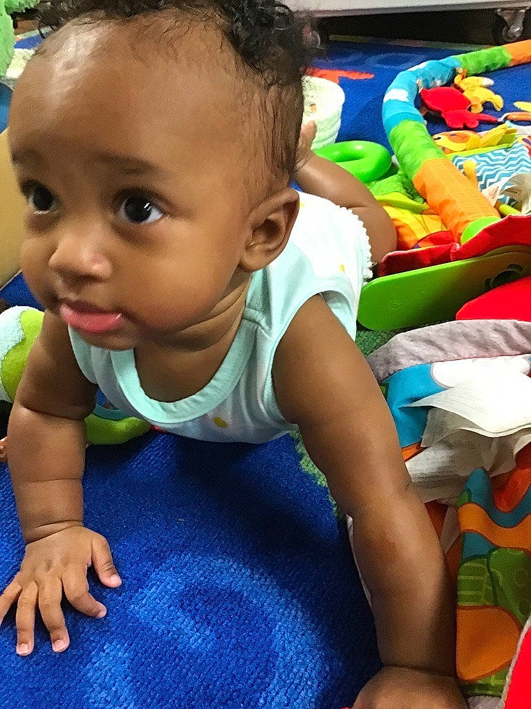 Irie joined the competition — help win amazing prizes! adaptation, baby, baby_toddler_clothing, blue, cheek, child, flooring, fun, green, happy, human, leisure, mammal, person, play, product, sitting, skin, t_shirt, toddler