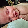 Elodie is registered to the contest to win money with this photo: baby, sleeping, closeup, infant, smile, skin, hand, fingers, face, peaceful, rest, blanket, soft, indoors, newborn, lying_down, cozy, cute, child, relaxation