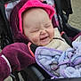 Valerian Jo is registered to the contest to win money with this photo: baby, child, stroller, blanket, hooded_jacket, purple, pink, smile, happy, outdoor, face, person, infant, clothing, baby_boy, baby_girl, cute, warm, seated, cozy