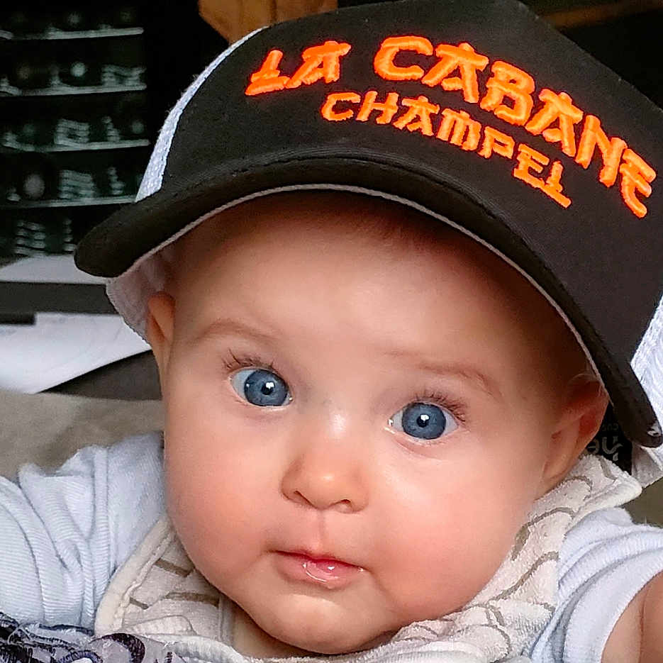 Eulalia participe au concours pour gagner de l'argent avec cette photo : apparel, baby, blue_eyes, cap, child, chubby_cheeks, closeup, clothing, cute, expression, face, hat, headwear, indoor, infant, looking, person, portrait, sitting, young_child