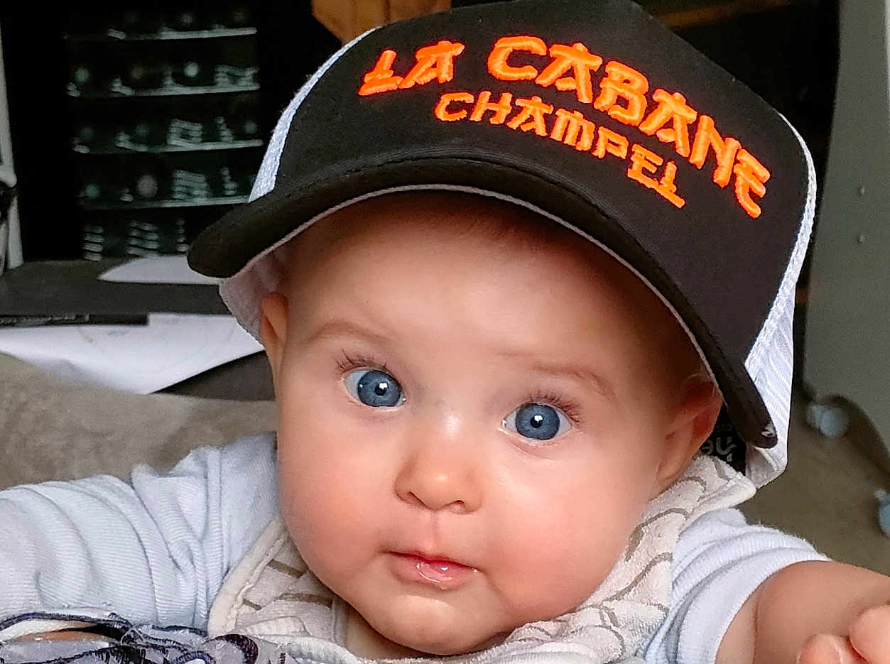 Eulalia participe au concours pour gagner de l'argent avec cette photo : baby, blue_eyes, cap, hat, face, infant, child, cute, chubby_cheeks, clothing, indoor, person, portrait, closeup, expression, sitting, looking, young_child, headwear, apparel