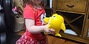 Emalee joined the competition — help win amazing prizes! barefoot, black_leggings, cabinet, carpet, child, curly_hair, cute, fish_toy, floor, girl, home, indoor, person, play, polka_dot_skirt, red_shirt, toy, wooden_furniture, yellow_toy, young_child