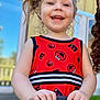 Emalee joined the competition — help win amazing prizes! background, child, closeup, clothing, curly_hair, daylight, earrings, elmo_pattern, face, hair, hand, handlebar, happy, outdoor, person, playful, red_dress, smiling, toddler, window