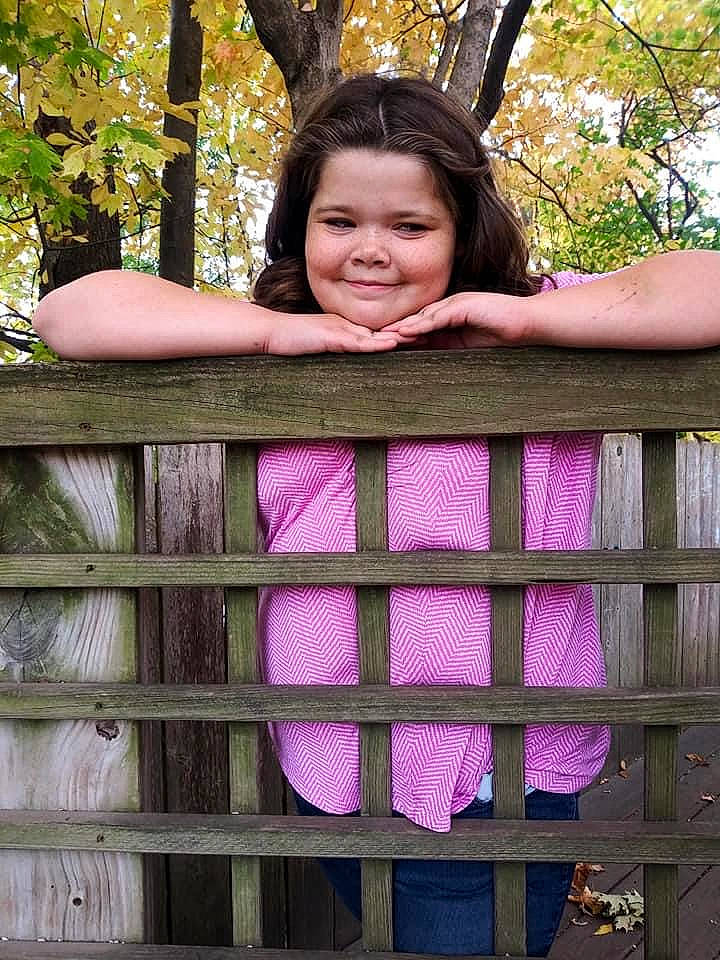 Hannah is registered to the contest to win money with this photo: beauty, child, child_model, dress, face, facial_expression, finger, green, hand, happy, joy, long_hair, magenta, person, photo_shoot, photography, pink, plant, purple, smile