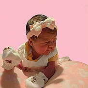 Gracie joined the competition — help win amazing prizes! baby, infant, pink_background, white_mittens, headband, bow, blanket, newborn, cute, sleepy, soft_texture, portrait, child, baby_clothing, indoor, resting, small_hands, peaceful, young_child, closeup