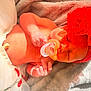 Gracie is registered to the contest to win money with this photo: baby, newborn, infant, pacifier, headband, flower_headband, tulle, cherry_pattern, blanket, sleeping, hand, hospital_id_band, closeup, portrait, soft_texture, skin, cute, red_accessory, nursery, outfit