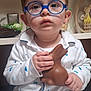 Maélän participe au concours pour gagner de l'argent avec cette photo : child, toddler, baby, glasses, blue_glasses, pajamas, chocolate, bunny, toy, hands, face, portrait, indoor, shelf, wooden_toy, expression, closeup, sitting, snack, eyes