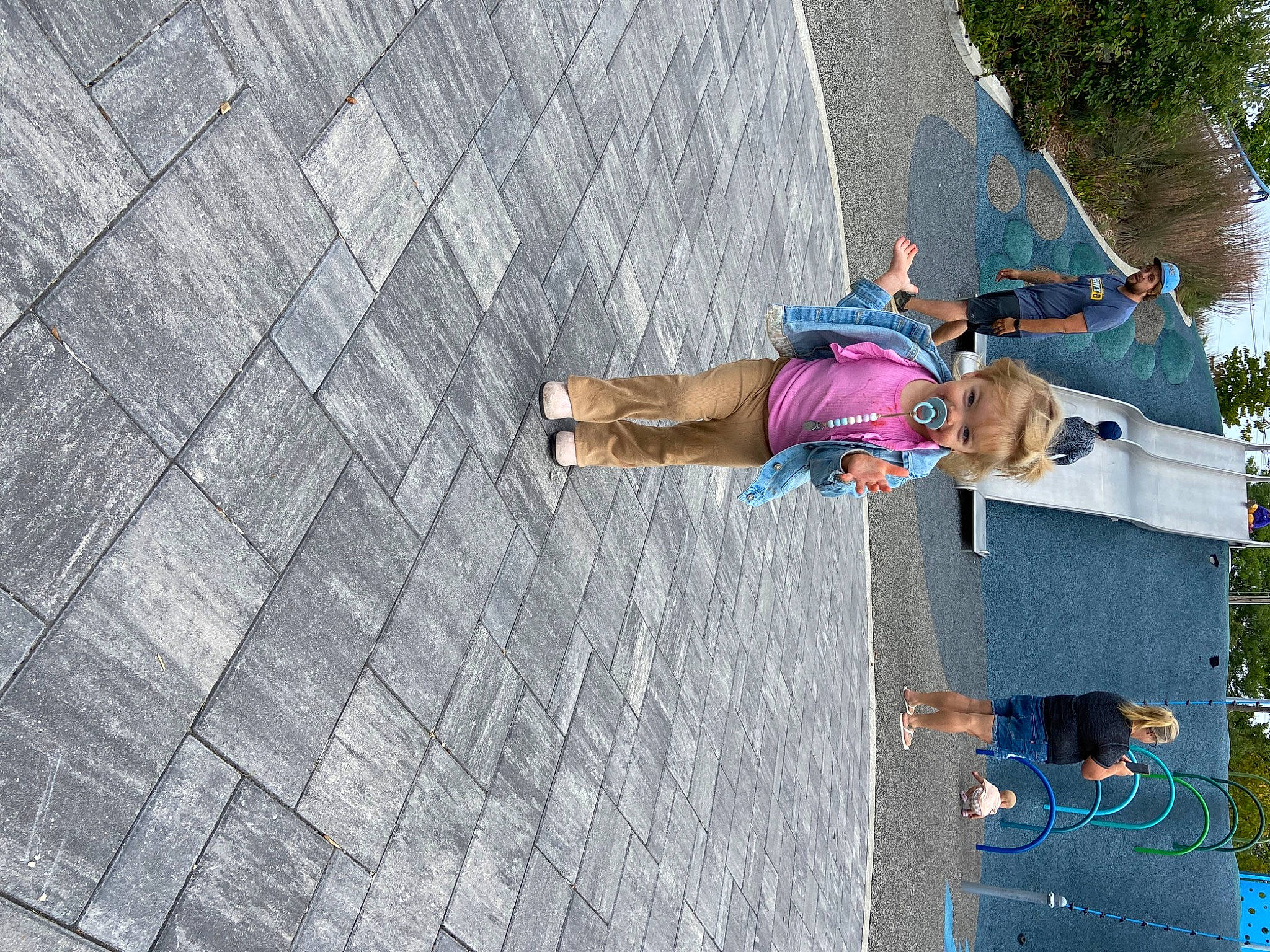 Teagan is registered to the contest to win money with this photo: adventure, asphalt, child, cobblestone, concrete, facade, flooring, fun, headwear, human_leg, leisure, pattern, pedestrian, person, plant, recreation, road, road_surface, sidewalk, street