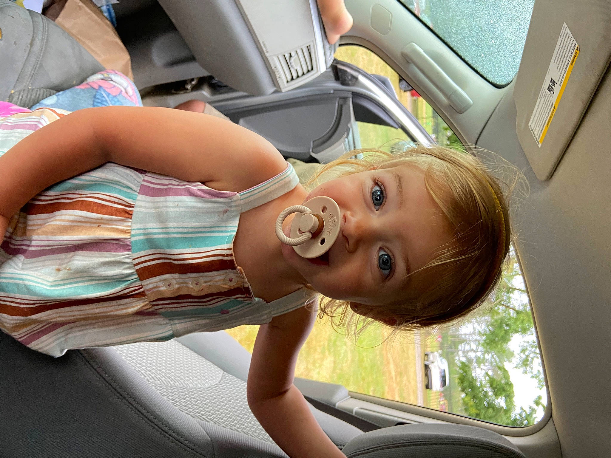 Teagan is registered to the contest to win money with this photo: auto_part, automotive_design, automotive_exterior, car, car_seat, child, comfort, family_car, fun, leisure, luxury_vehicle, motor_vehicle, person, sunglasses, toddler, tree, vacation, vehicle, vehicle_door, window