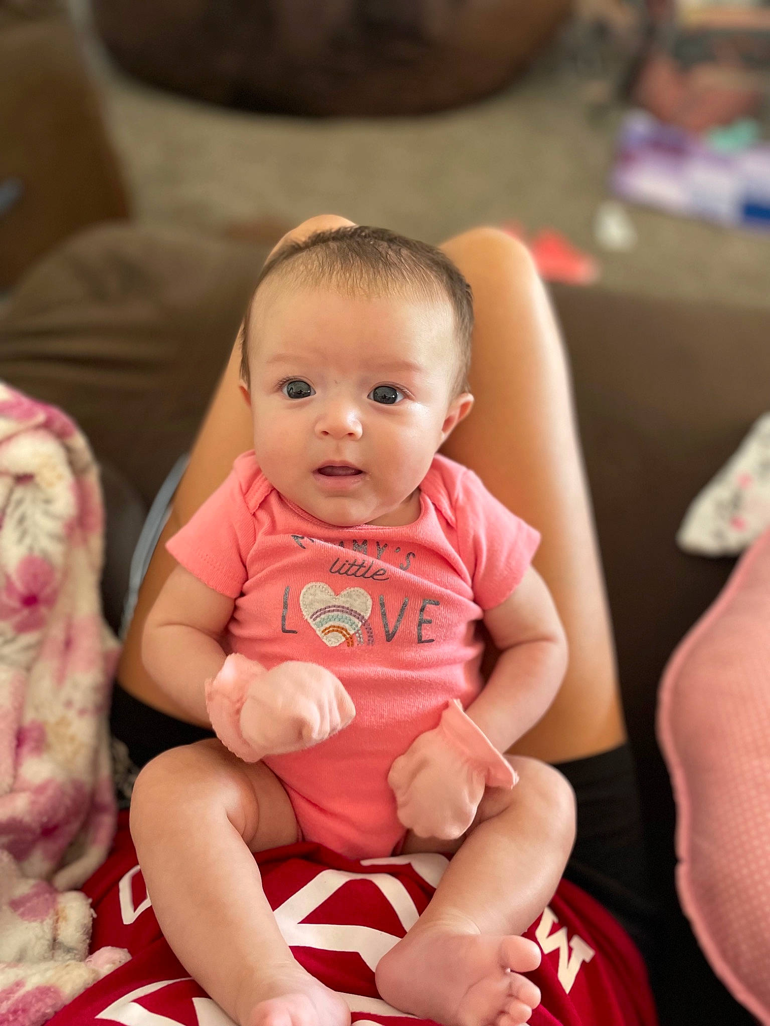 Avery is registered to the contest to win money with this photo: baby, baby_toddler_clothing, chair, cheek, comfort, event, eye, flooring, fun, happy, human_body, human_leg, iris, lap, mouth, person, sitting, skin, smile, thigh