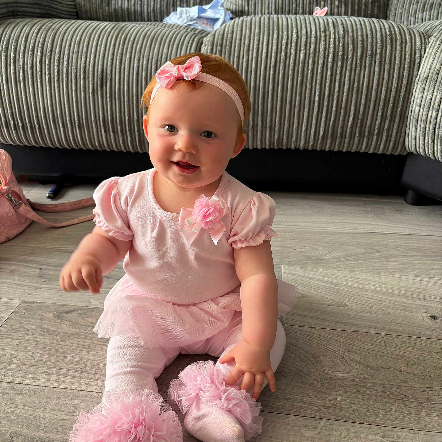 Joanie-May is registered to the contest to win money with this photo: baby, child, couch, cute, decor, floor, girl, happy, headband, home, indoor, infant, person, pink_clothing, portrait, sitting, smile, sock, toddler, tulle