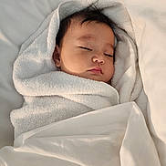 Chadric Ashton is registered to the contest to win money with this photo: baby, bed, bedding, blanket, closed_eyes, cozy, face, head, indoors, infant, nap, newborn, peaceful, photography, portrait, resting, sleeping, snug, soft_lighting, white_blanket