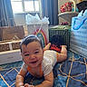 Chadric Ashton is registered to the contest to win money with this photo: baby, child, infant, smiling, happy, lying_down, bed, blanket, bedroom, gifts, gift_bags, tissue_paper, balloon, birthday, window, curtains, furniture, clothing, portrait, indoors