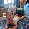 baby, child, infant, smiling, portrait, bed, bedroom, gift_bags, gift_boxes, tissue_paper, window, curtains, blanket, clothing, lying_down, indoor, happy, face, toys, celebration