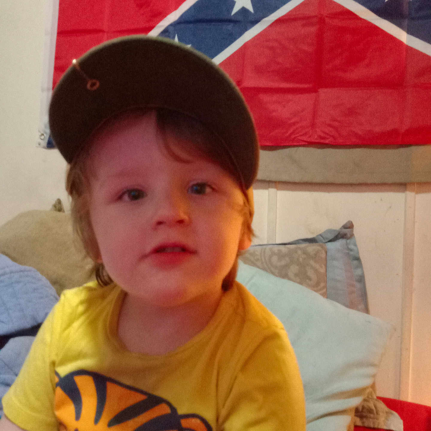 Dereck joined the competition — help win amazing prizes! americanflag, baby, baseballcap, boy, cap, child, clothing, couch, cowboyhat, cushion, emblem, face, flag, furniture, hat, head, homedecor, male, person, photography