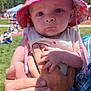 baby, child, person, hand, hat, outdoor, sky, cloud, grass, sunlight, adult_hand, plaid_shirt, fingers, holding, summer, nature, people, face, expression, portrait