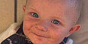 Oakley joined the competition — help win amazing prizes! apparel, baby, blue_eyes, child, closeup, clothing, cute, dinosaur_print, eyewear_reflection, face, happy, head, indoors, infant, person, portrait, sitting, skin, smile, young