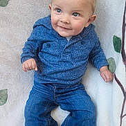 Oakley is registered to the contest to win money with this photo: baby, child, blue_eyes, blue_sweater, jeans, sitting, blanket, smiling, cute, indoor, infant, clothing, portrait, toddler, happy, young_child, casual_wear, socks, face, person