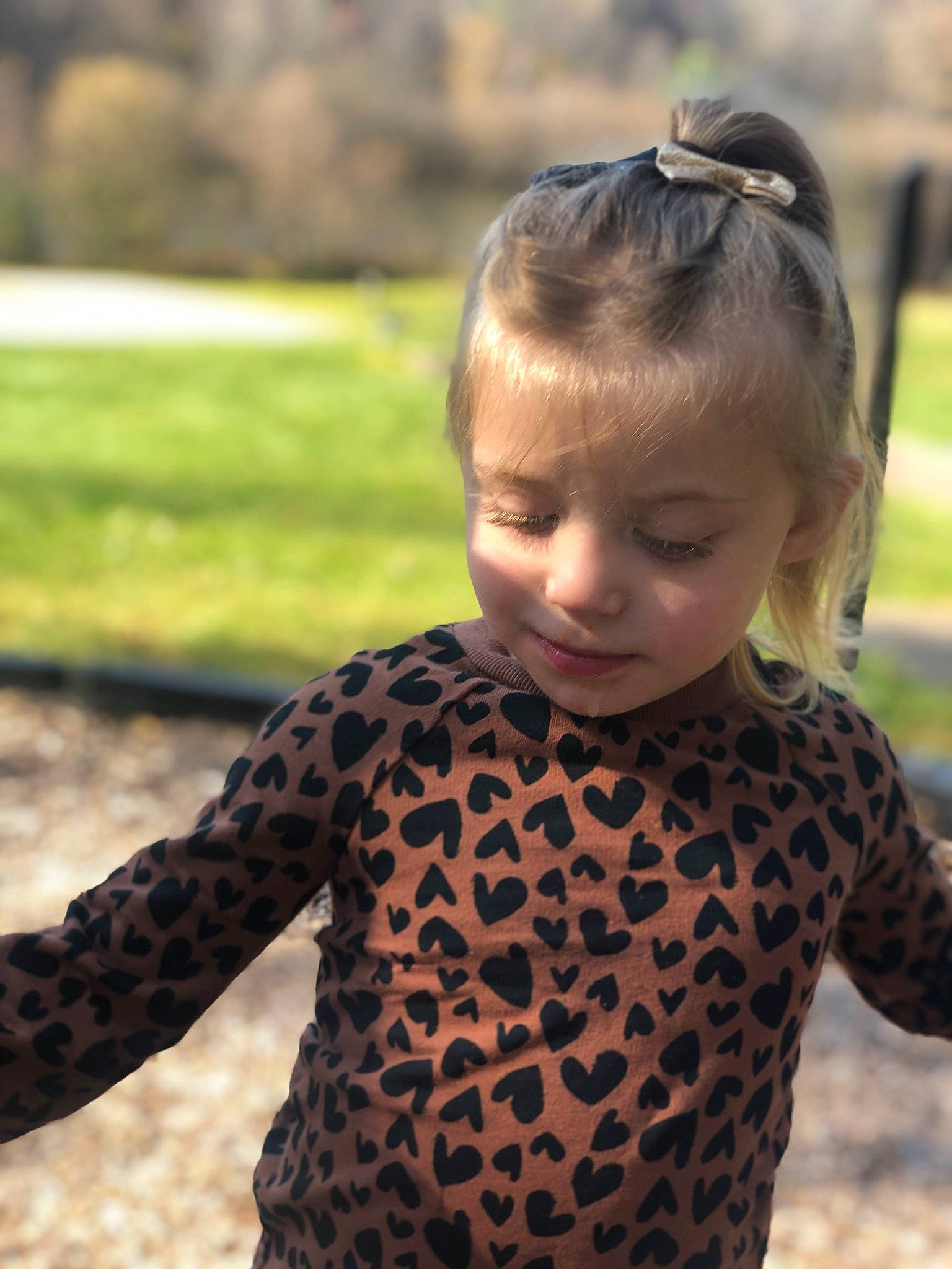 Evalynn is registered to the contest to win money with this photo: baby_toddler_clothing, child, eyewear, facial_expression, fawn, fun, grass, happy, head, lip, neck, outerwear, pattern, people_in_nature, person, shoulder, sleeve, sunglasses, t_shirt, toddler