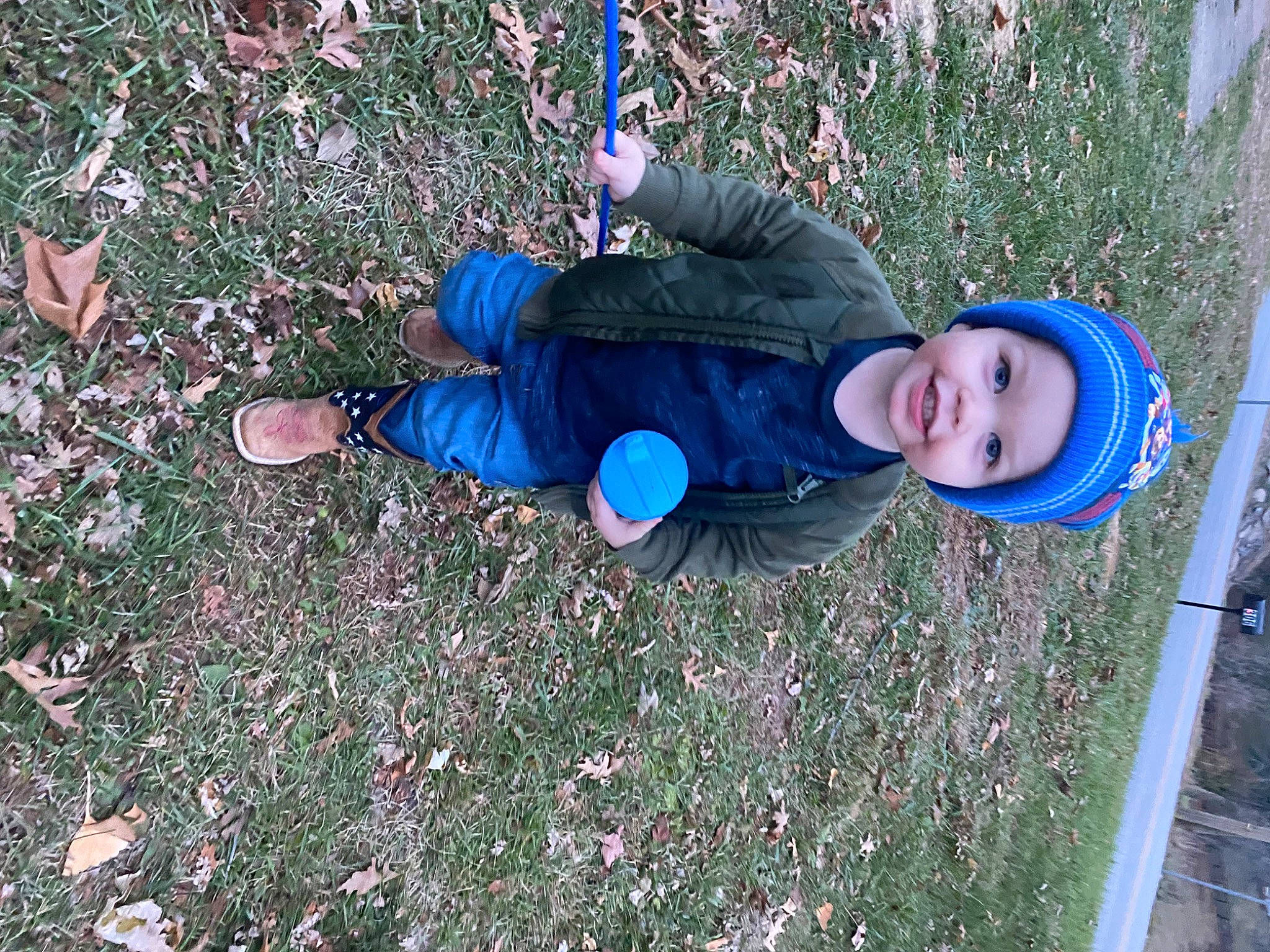 Kylin is registered to the contest to win money with this photo: baby_toddler_clothing, child, electric_blue, fun, grass, headwear, lawn, leisure, people_in_nature, person, plant, play, recreation, shadow, smile, soil, toddler, tree, winter, yard