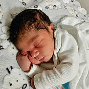 Zaylin Graf is registered to the contest to win money with this photo: newborn, baby, sleeping, infant, portrait, face, curled_up, blanket, white_clothing, bedding, indoors, peaceful, resting, closed_eyes, dark_hair, fair_skin, hand, sheep_pattern, cozy, photography