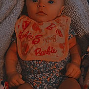 Brinley Rose joined the competition — help win amazing prizes! baby, infant, bib, blanket, clothing, patterned_clothing, face, hands, legs, blue_eyes, expression, portrait, indoor, cute, child, newborn, soft_texture, comfort, lying_down, casual