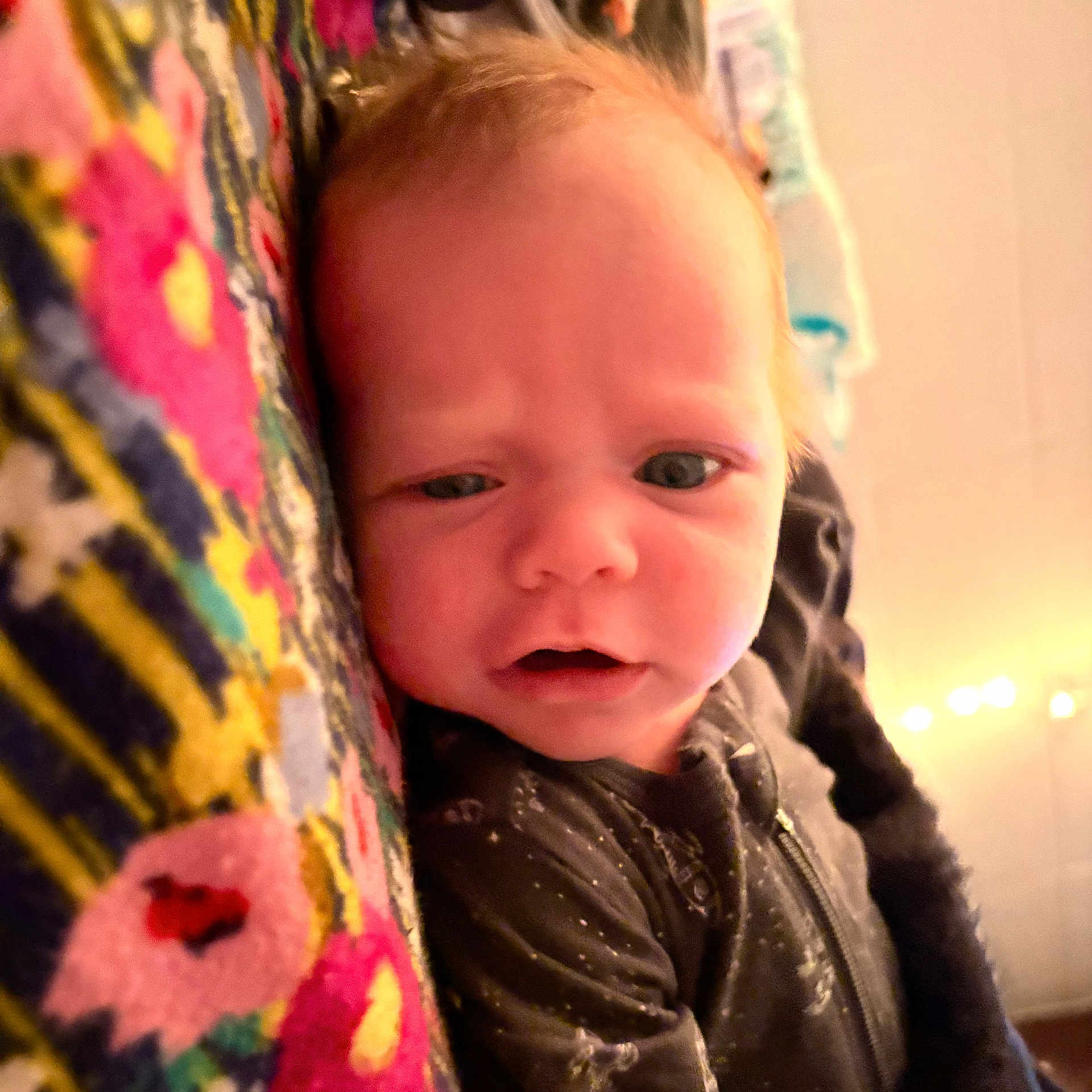 Oakleigh joined the competition — help win amazing prizes! baby, infant, face, closeup, blanket, pattern, colorful, expression, curious, soft_light, indoors, cozy, sleepwear, person, young_child, portrait, skin, head, young, cute