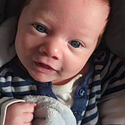 Dante joined the competition — help win amazing prizes! baby, infant, face, blue_eyes, blanket, striped_clothing, hand, soft_texture, cute, portrait, close_up, skin, newborn, child, cozy, smile, person, indoors, young, head