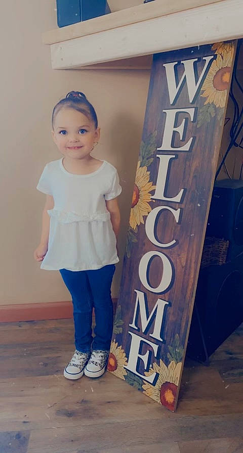 Skylynn is registered to the contest to win money with this photo: azure, baby_toddler_clothing, child, denim, electric_blue, fashion_design, flooring, font, fun, happy, joy, knee, person, room, sleeve, smile, street_fashion, t_shirt, toddler, visual_arts